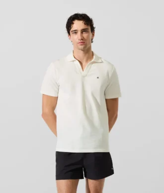 Polo med monogramnål Polo med monogramnål